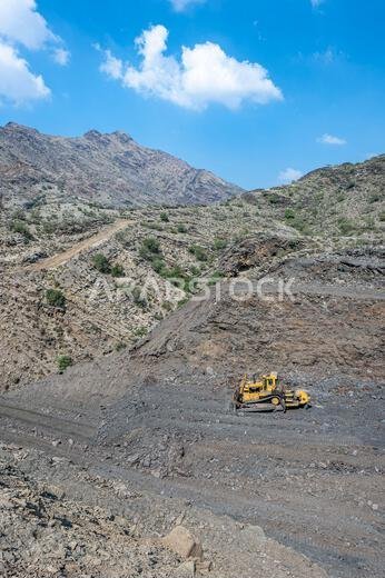 Heavy machinery in the process of mountain road construction works in Saudi Arabia Heavy machinery in the process of mountain road construction works in Saudi Arabia