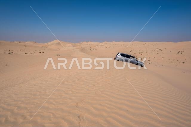 سيارة دفع رباعي في منطقة القدرة، الربع الخالي، صحراء متصلة في دبي، الإمارات العربية المتحدة، الشرق الأوسط، مع مسارات الرياح وكثبان رملية وسماء رمادية ملبدة بالغيوم