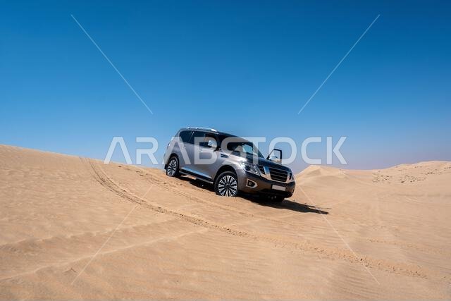SUV four wheel drive vehicle car Al Qudra empty quarter seamless desert sahara in Dubai UAE middle east with wind paths and sand hills gray cloudy sky SUV four wheel drive vehicle car Al Qudra empty quarter seamless desert sahara in Dubai UAE middle east with wind paths and sand hills gray cloudy sky