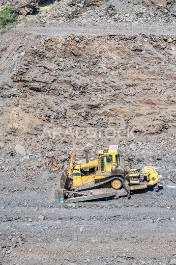 Heavy machinery in the process of mountain road construction works in Saudi Arabia