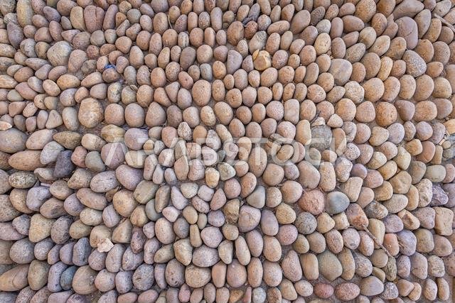 Middle East, Saudi Arabia, Tabuk, Duba. Wall made of rounded stones.