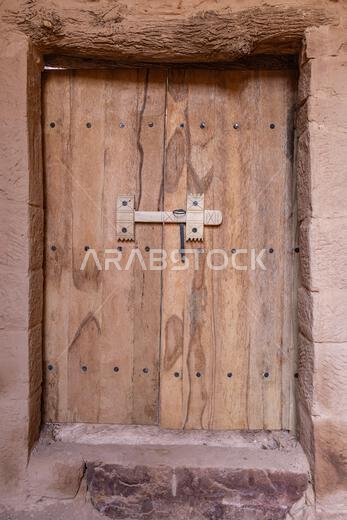 Middle East, Saudi Arabia, Medina, Al-Ula. Wooden door on a building in old town Al-Ula.
