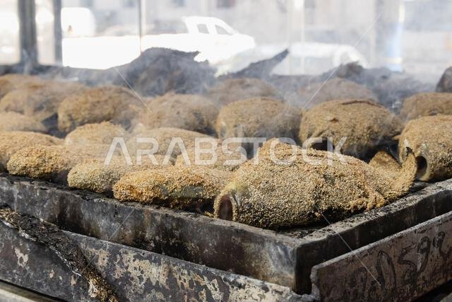 Middle East, Saudi Arabia, Madinah Province, Medina.  Fresh fish cooking at a market in Medina.