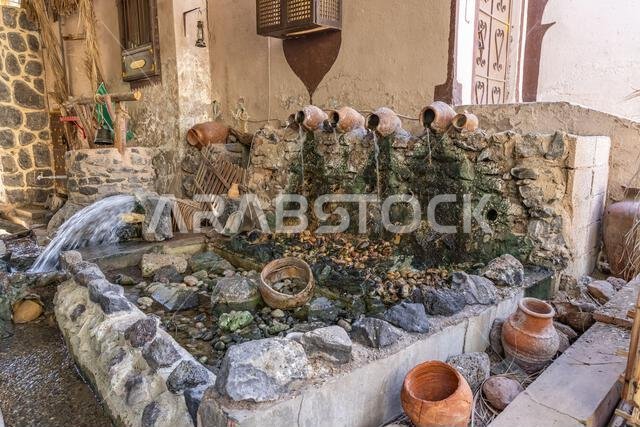 Middle East, Saudi Arabia, Madinah Province, Medina. Water pouring from an artesian well in Medina.