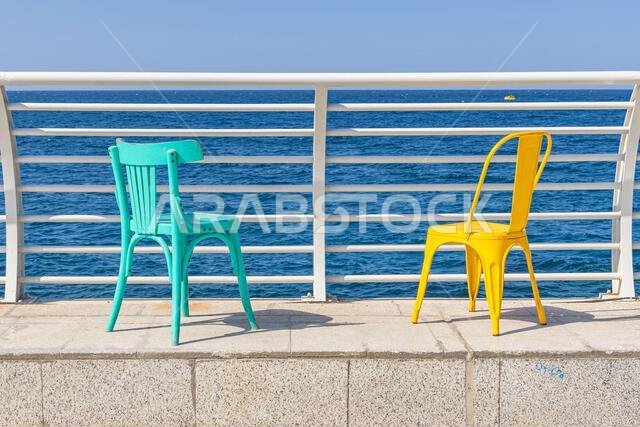 Middle East, Saudi Arabia, Mecca Province, Jeddah. Colorful chairs on the waterfront of Jeddah.