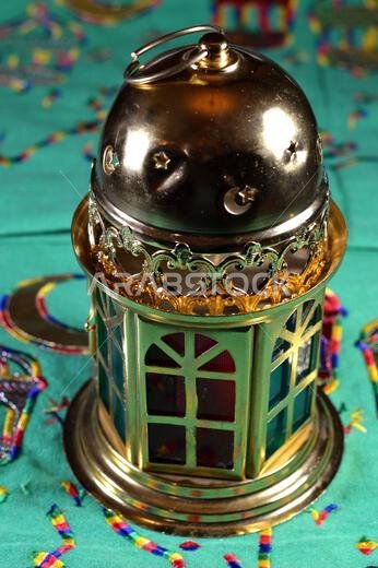 Ramadan Lantern lamp or Fanous Ramadan on a green background as a festive celebration of the Islamic fasting days in Arabian Islamic countries, religi