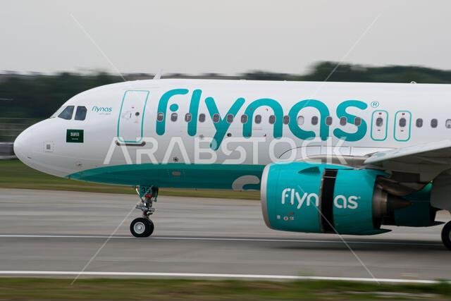 Saudi low-cost airline's Flynas Airbus A320 NEO close-up while slowing down after landing at Lviv, with reverse thrust on