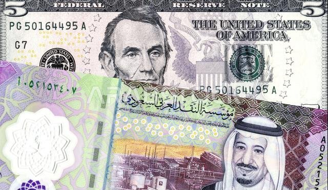 Saudi Arabia Riyal banknote with King Salman, American dollars banknote with Abraham Lincoln. Business concept of the exchange rate, stock exchange, t