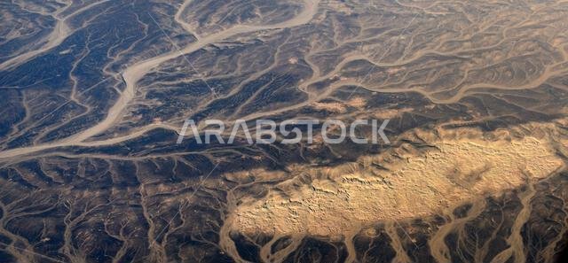 A Surreal aerial view of dried river beds in the desert in Jordan near the border with Saudi Arabia.