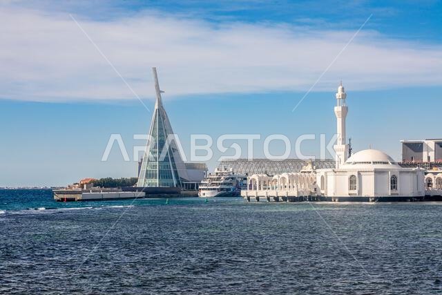 Alrahmah floating mosque with modern building and port and sea in foreground, Jeddah, Saudi Arabia Alrahmah floating mosque with modern building and port and sea in foreground, Jeddah, Saudi Arabia