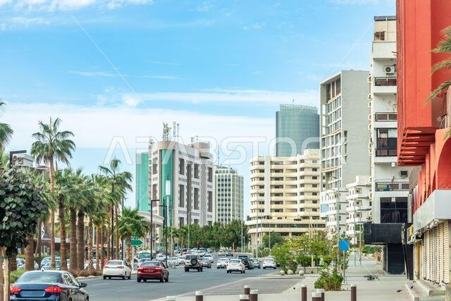 Jeddah downtown central district street with road full of car traffic and modern buildings in the background, Saudi Arabia