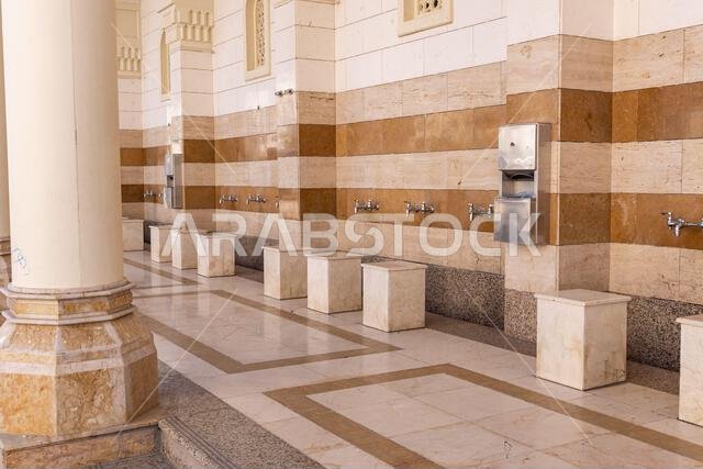 Middle East, Saudi Arabia, Madinah Province, Medina. November 20, 2023. Washing feet before entering Fash Mosque below Mount Uhud.