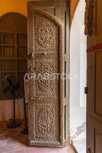 Middle East, Saudi Arabia, Mecca Province, Jeddah. November 21, 2023. Ornately carved wooden door in the Al-Balad district.