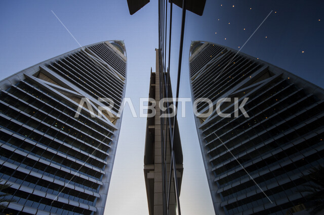 Aesthetic image of the reflection of Al-Faisaliah Tower on the glass in the city of Riyadh in the Kingdom of Saudi Arabia, the towers of the city of Riyadh, famous landmarks in Riyadh, the architectural art in Saudi Arabia, tourism in Saudi Arabia