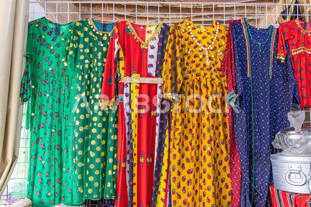 Middle East, Saudi Arabia, Al-Qassim, Unaizah. Women's dresses at a market in Unaizah.