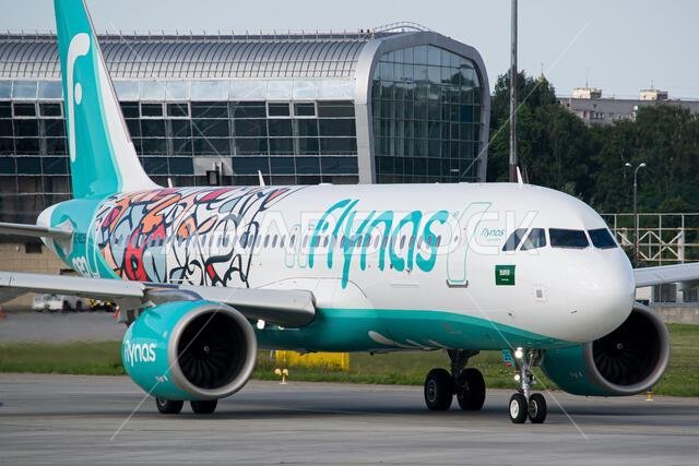 Close-up of a Saudi airline's Flynas Airbus A320 NEO in a "Year of Arabic Calligraphy" livery taxiing for takeoff from Lviv Airport