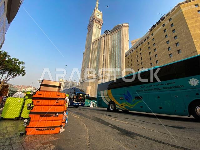 Mecca, Saudi Arabia - August 26, 2023: Orange Luggage seen in front of hotel near Kaaba, Mecca, Saudi Arabia during umrah period