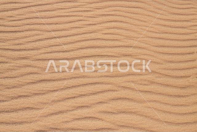 Desert sand pattern during the day light. wave sand parttern of the desert isolated. Desert sand after wind isolated.