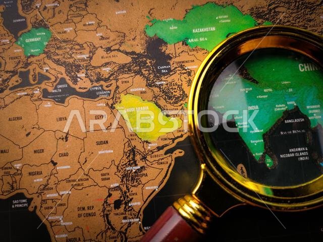 Top view vintage magnifying glass and world map focus to SAUDI ARABIA map