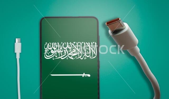 USB-C cable and a smartphone with the Saudi Arabia Flag on screen