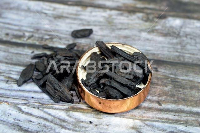 Saudi Oud incense, an aromatic biotic material that releases fragrant smoke when burnt. The term is used for either the material or the aroma, compose