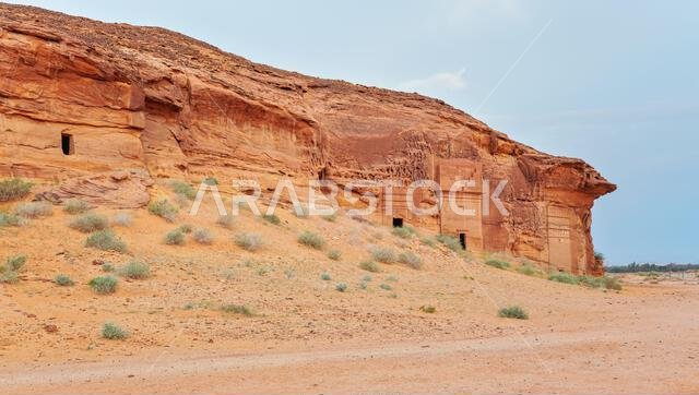 Old Nabatean architecture carved on orange sandstone wall at Jabal Al Ahmar, Hegra in Saudi Arabia, 18 ancient tombs are located here, 111 in whole