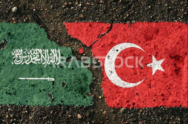 On the pavement there are images of the flags of Saudi Arabia and Turkey, as a symbol of confrontation. Conceptual image. On the pavement there are images of the flags of Saudi Arabia and Turkey, as a symbol of confrontation. Conceptual image.