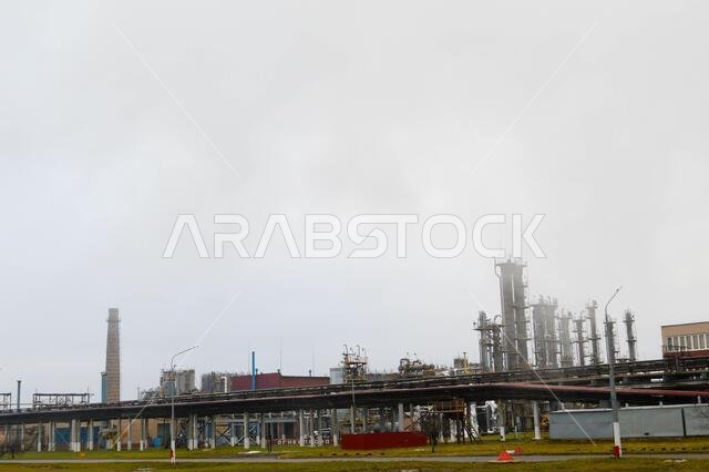 Oil refinery, petrochemical plant, in cloudy weather, fog.