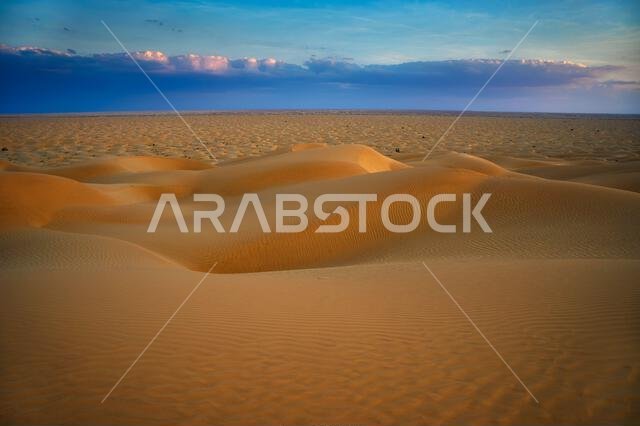 Sunset over the sand dunes of the Arabian Desert in Oman