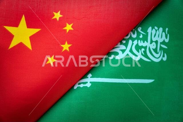 Background of the flags of the saudi arabia and China. The concept of interaction or counteraction between the two countries. International relations.