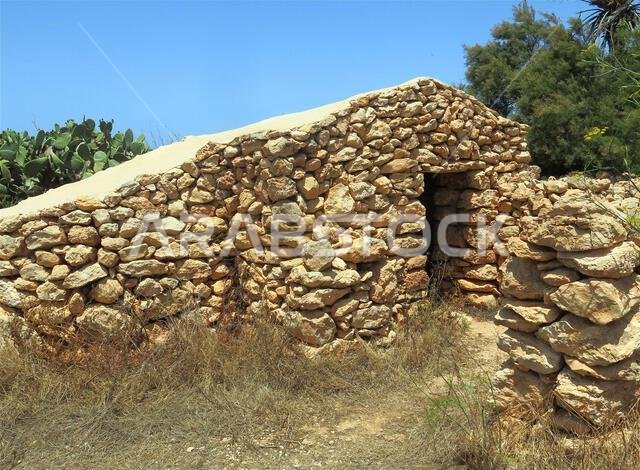 houses built with dry stone walls typical of the warm Mediterranean areas in summer houses built with dry stone walls typical of the warm Mediterranean areas in summer