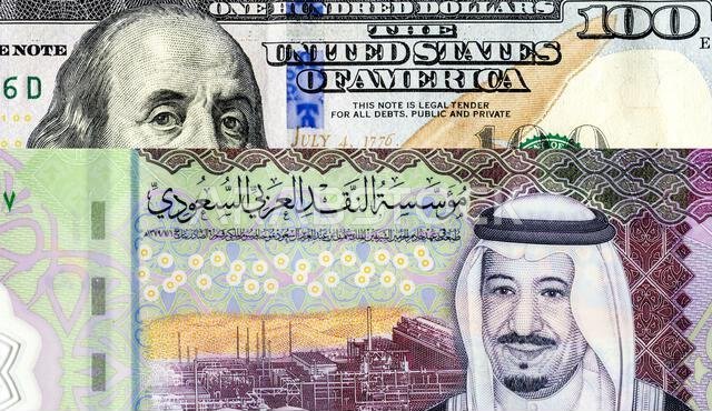 Saudi Arabia banknote with King Salman and American dollars banknote with Benjamin Franklin. Business concept of the exchange rate, stock exchange, tr