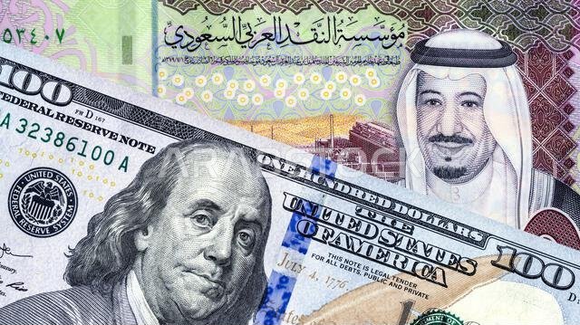American dollars banknote with Benjamin Franklin and Saudi Arabia banknote with King Salman. Business concept photo of the exchange rate, stock exchan