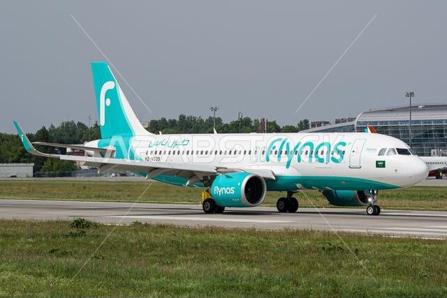 Flynas Airbus A320 taxiing to the gates after landing at Lviv Airport after a flight from Riyadh
