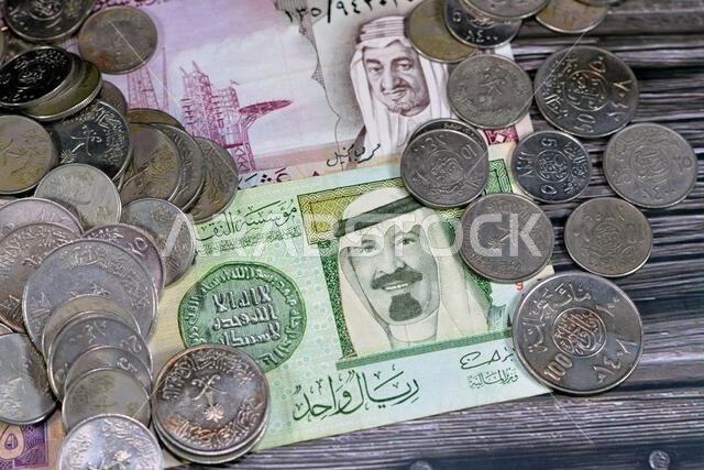 Saudi Arabia riyals money banknote bills and coins of different eras from the kingdom of Saudi Arabia times, vintage retro old Saudi currency, value,