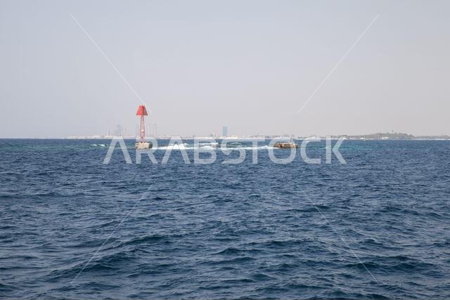 Red beacon tower is marking the border of a fairway to Jeddah Islamic Seaport. Framed structure with triangle top mark. Persian Gulf, Saudi Arabia