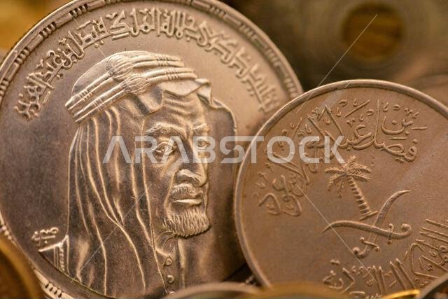 عملة سعودية قديمة من عهد الملك فيصل، وعملة مصرية من فئة جنيه مصري واحد (1 جنيه مصري) فضية تحمل شعار الملك فيصل بن عبد الله عملة سعودية قديمة من عهد الملك فيصل، وعملة مصرية من فئة جنيه مصري واحد (1 جنيه مصري) فضية تحمل شعار الملك فيصل بن عبد الله