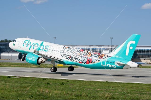 Saudi airline's Flynas Airbus A320 NEO in a "Year of Arabic Calligraphy" livery taking off from Lviv Airport for a flight to Riyadh