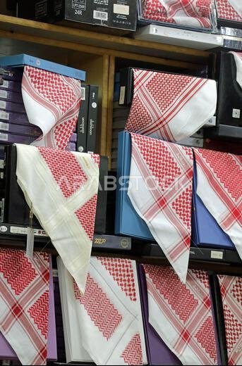 Red and white keffiyehs for sale in Saudi Arabia
