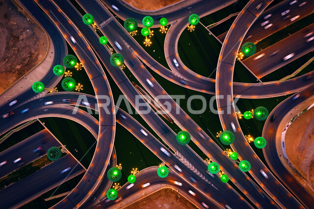 A view from above of the intersection of King Abdullah Road with King Khalid Road, aesthetic models in the form of green trees, Irqa roundabout in Riyadh, Saudi Arabia at night, tourist attractions