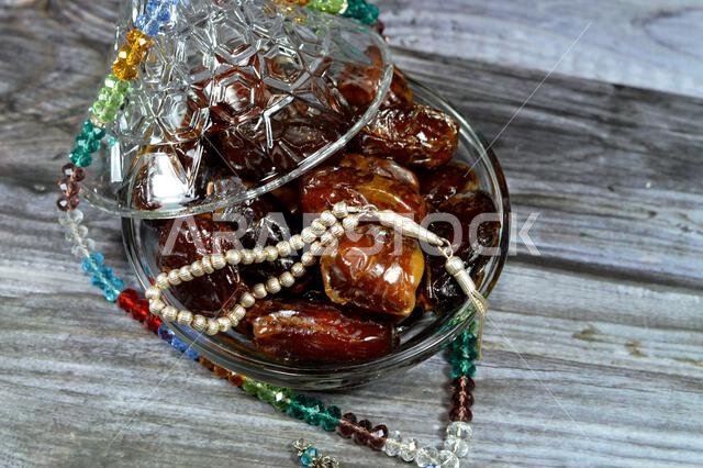 Ramadan background, Ajwa dates, a cultivar of the palm date that is widely grown in Medina, Saudi Arabia., an oval-shaped, medium-sized date, and Isla Ramadan background, Ajwa dates, a cultivar of the palm date that is widely grown in Medina, Saudi Arabia., an oval-shaped, medium-sized date, and Isla