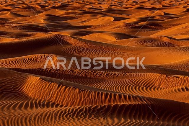Close-up full frame view of orange sand dunes in the desert, Saudi Arabia