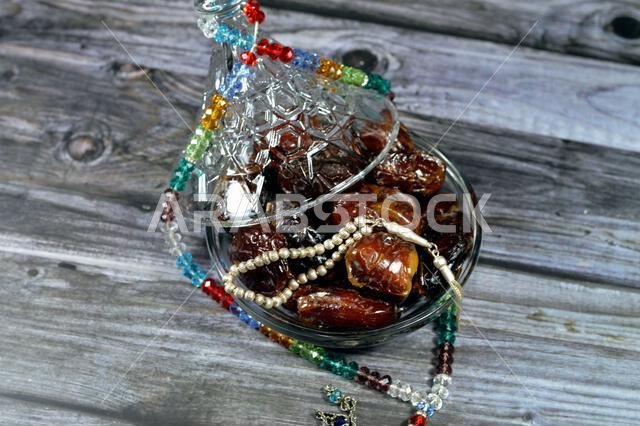 Ramadan background, Ajwa dates, a cultivar of the palm date that is widely grown in Medina, Saudi Arabia., an oval-shaped, medium-sized date, and Isla Ramadan background, Ajwa dates, a cultivar of the palm date that is widely grown in Medina, Saudi Arabia., an oval-shaped, medium-sized date, and Isla