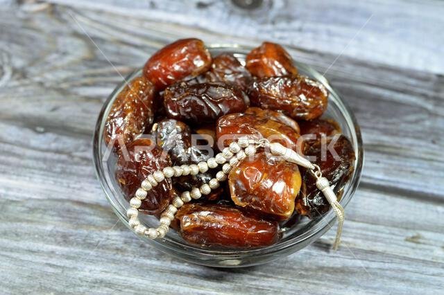 Ramadan background, Ajwa dates, a cultivar of the palm date that is widely grown in Medina, Saudi Arabia., an oval-shaped, medium-sized date, and an I