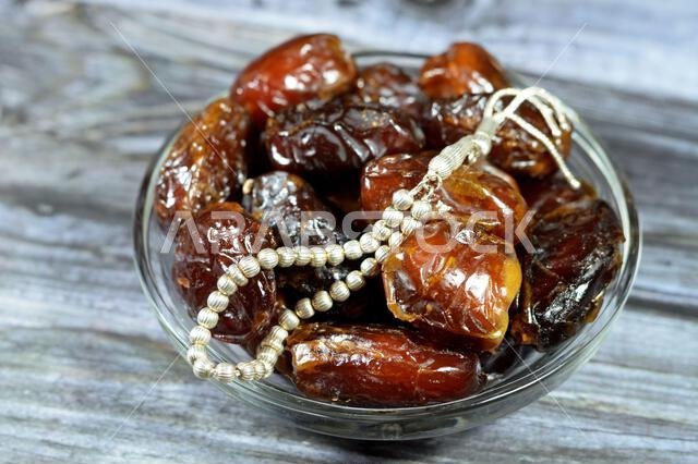 Ramadan background, Ajwa dates, a cultivar of the palm date that is widely grown in Medina, Saudi Arabia., an oval-shaped, medium-sized date, and an I Ramadan background, Ajwa dates, a cultivar of the palm date that is widely grown in Medina, Saudi Arabia., an oval-shaped, medium-sized date, and an I