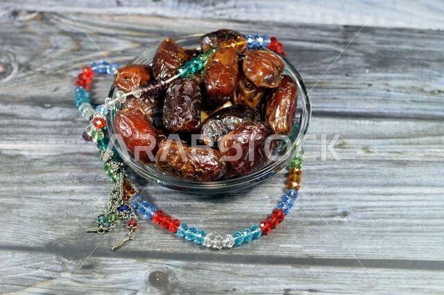 Ramadan background, Ajwa dates, a cultivar of the palm date that is widely grown in Medina, Saudi Arabia., an oval-shaped, medium-sized date, and an I Ramadan background, Ajwa dates, a cultivar of the palm date that is widely grown in Medina, Saudi Arabia., an oval-shaped, medium-sized date, and an I