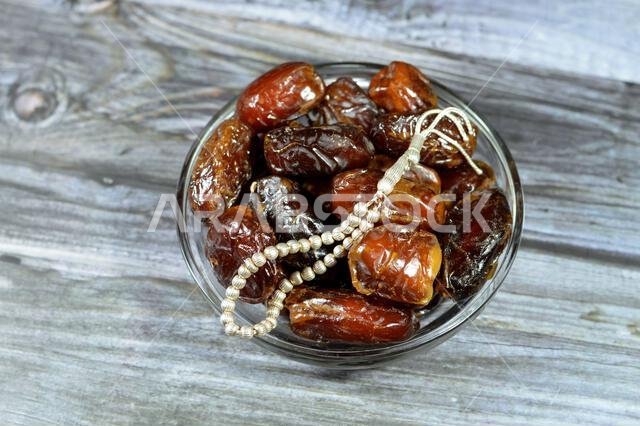 Ramadan background, Ajwa dates, a cultivar of the palm date that is widely grown in Medina, Saudi Arabia., an oval-shaped, medium-sized date, and an I Ramadan background, Ajwa dates, a cultivar of the palm date that is widely grown in Medina, Saudi Arabia., an oval-shaped, medium-sized date, and an I