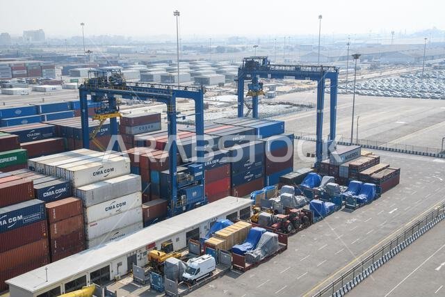 Jeddah, Saudi Arabia - December 21, 2022: Port cranes for loading containers. View of the cargo port in Jeddah. Jeddah, Saudi Arabia - December 21, 2022: Port cranes for loading containers. View of the cargo port in Jeddah.