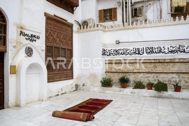 Jeddah, Saudi Arabia - December 21, 2022: Street life in the Old City. A place for prayer with sayings from the Koran on the walls. Historic Jeddah. Jeddah, Saudi Arabia - December 21, 2022: Street life in the Old City. A place for prayer with sayings from the Koran on the walls. Historic Jeddah.