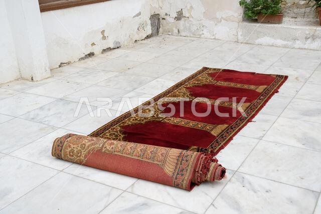Jeddah, Saudi Arabia - December 21, 2022: Street life in the Old City. Prayer rug in traditional style. Historic Jeddah. Jeddah, Saudi Arabia - December 21, 2022: Street life in the Old City. Prayer rug in traditional style. Historic Jeddah.